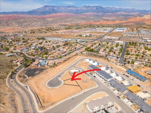 Aerial overview of property's location featuring nearby suburban area and mountains