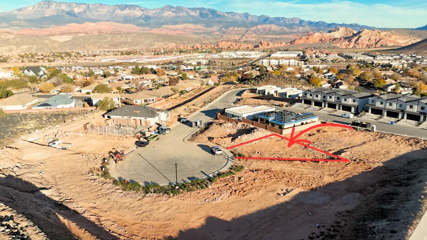 Aerial view of residential area featuring a mountainous background