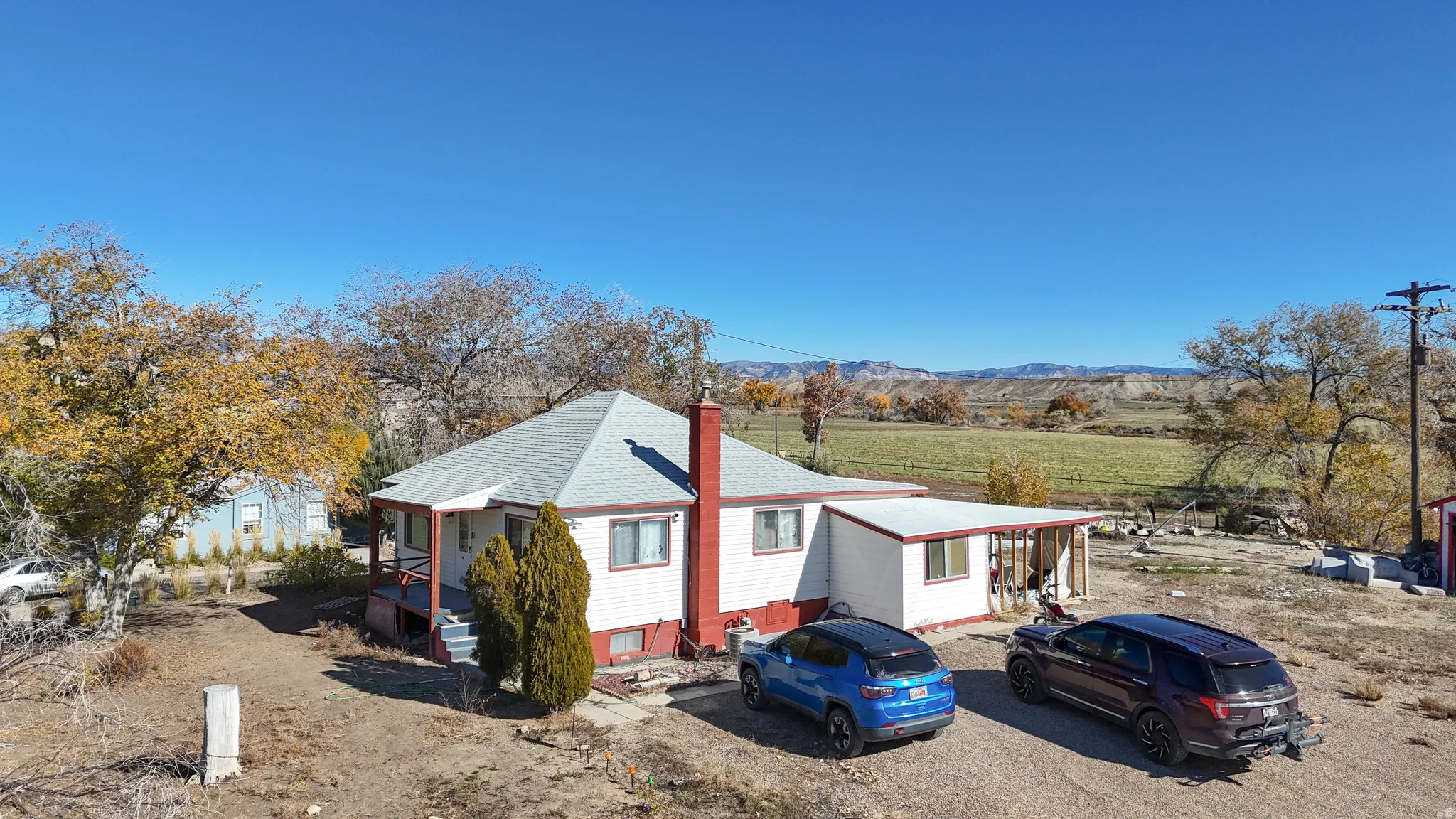 View of front of house featuring a view of rural / pastoral area, a chimney, and a mountain view