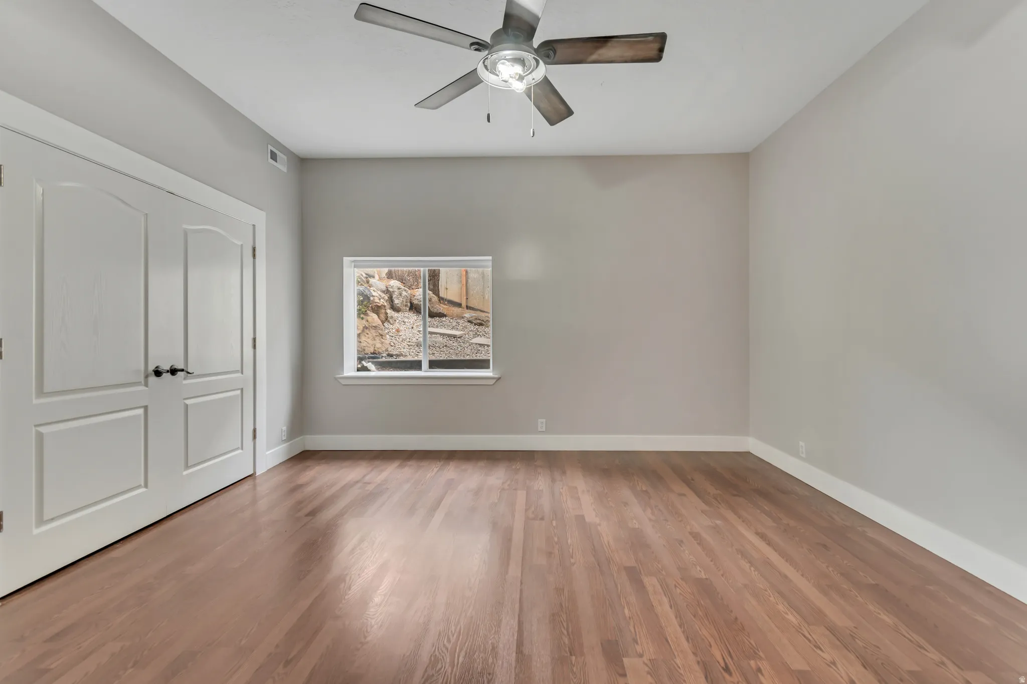 Unfurnished bedroom featuring light wood-style floors and a ceiling fan