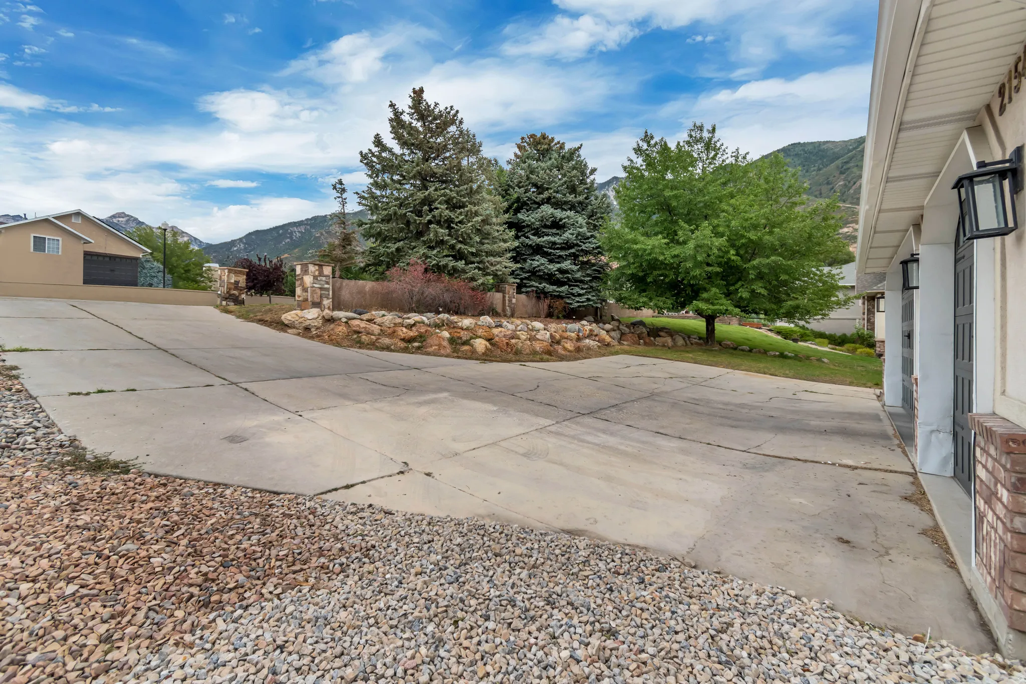View of patio / terrace featuring a mountain view and driveway