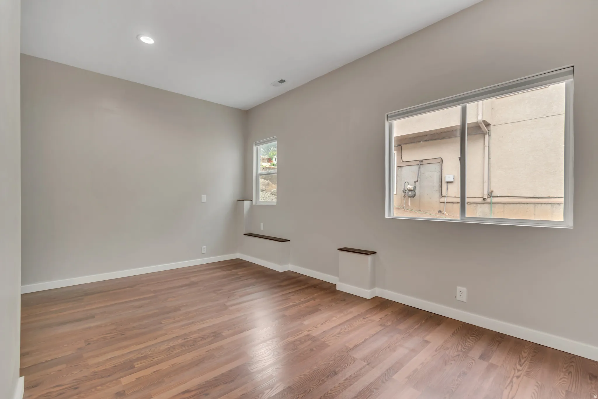 Empty room featuring light wood-style floors and recessed lighting