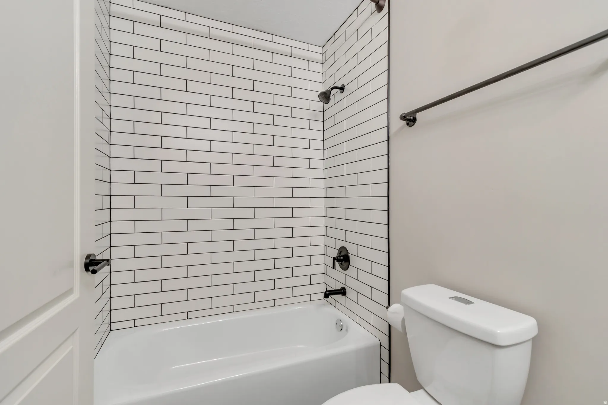 Bathroom featuring bathing tub / shower combination and toilet