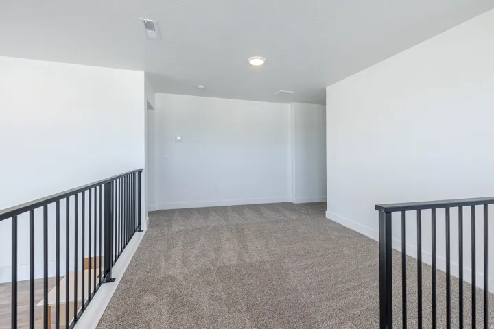 Unfurnished room with light carpet and baseboards