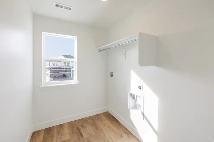 Laundry area featuring washer hookup, light wood-type flooring, and electric dryer hookup