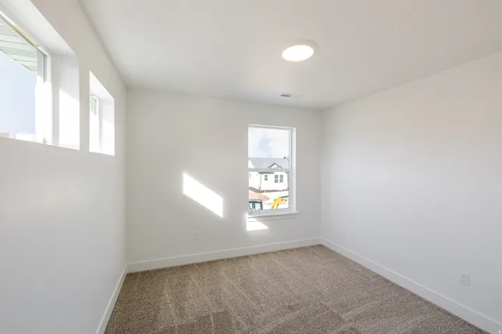 Unfurnished room with carpet floors and baseboards