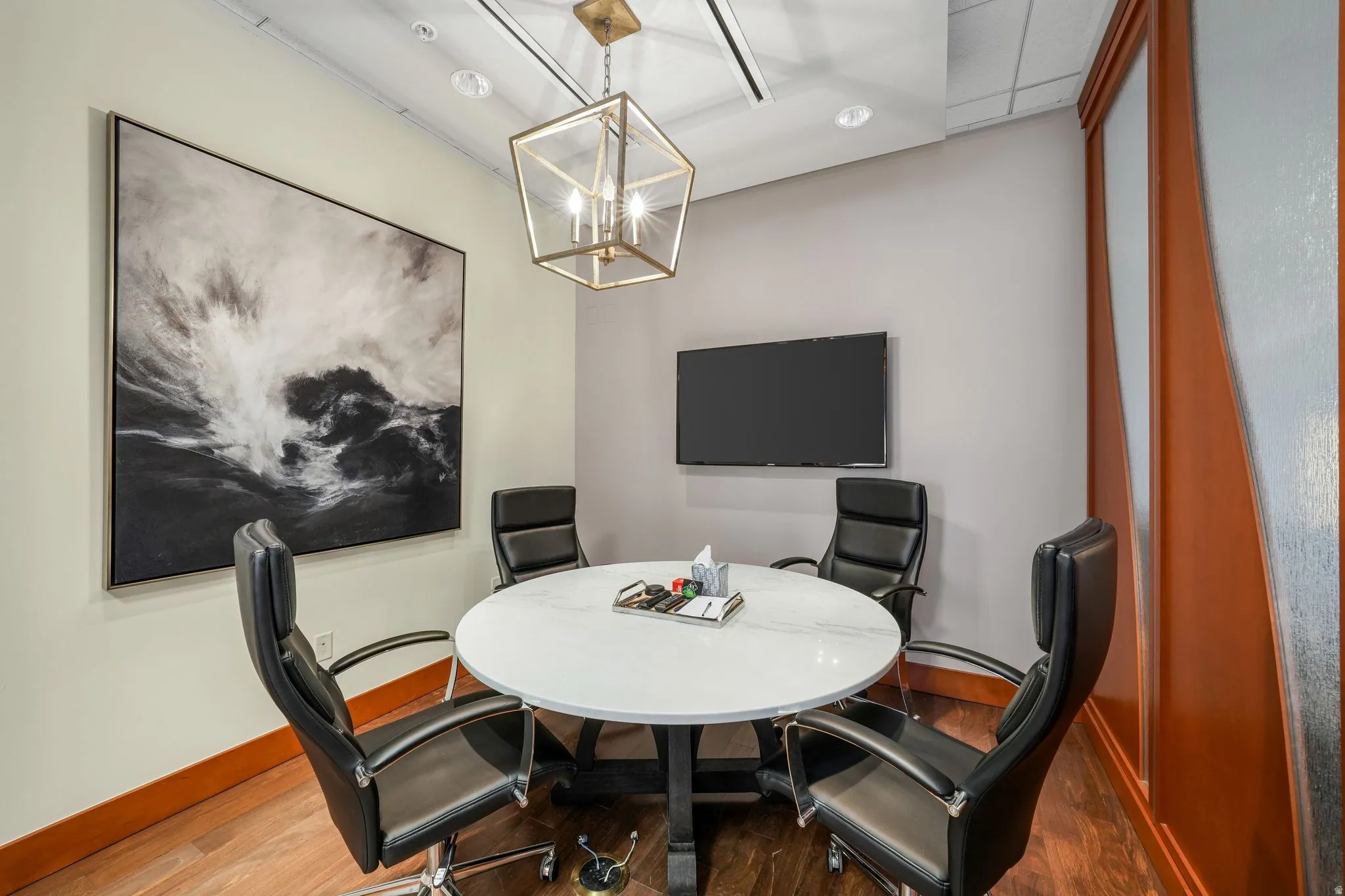 Office space featuring wood finished floors and a chandelier