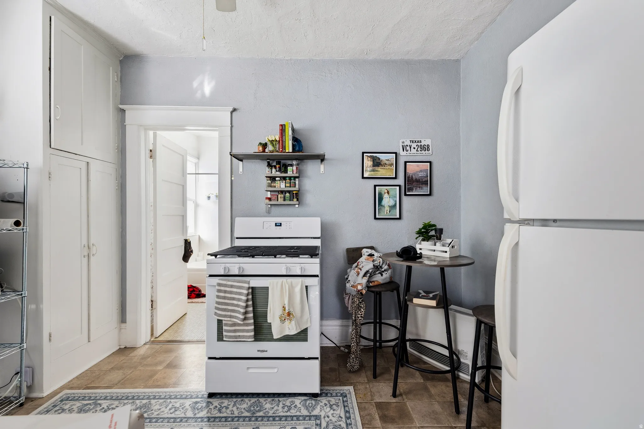 Kitchen with white appliances and open shelves