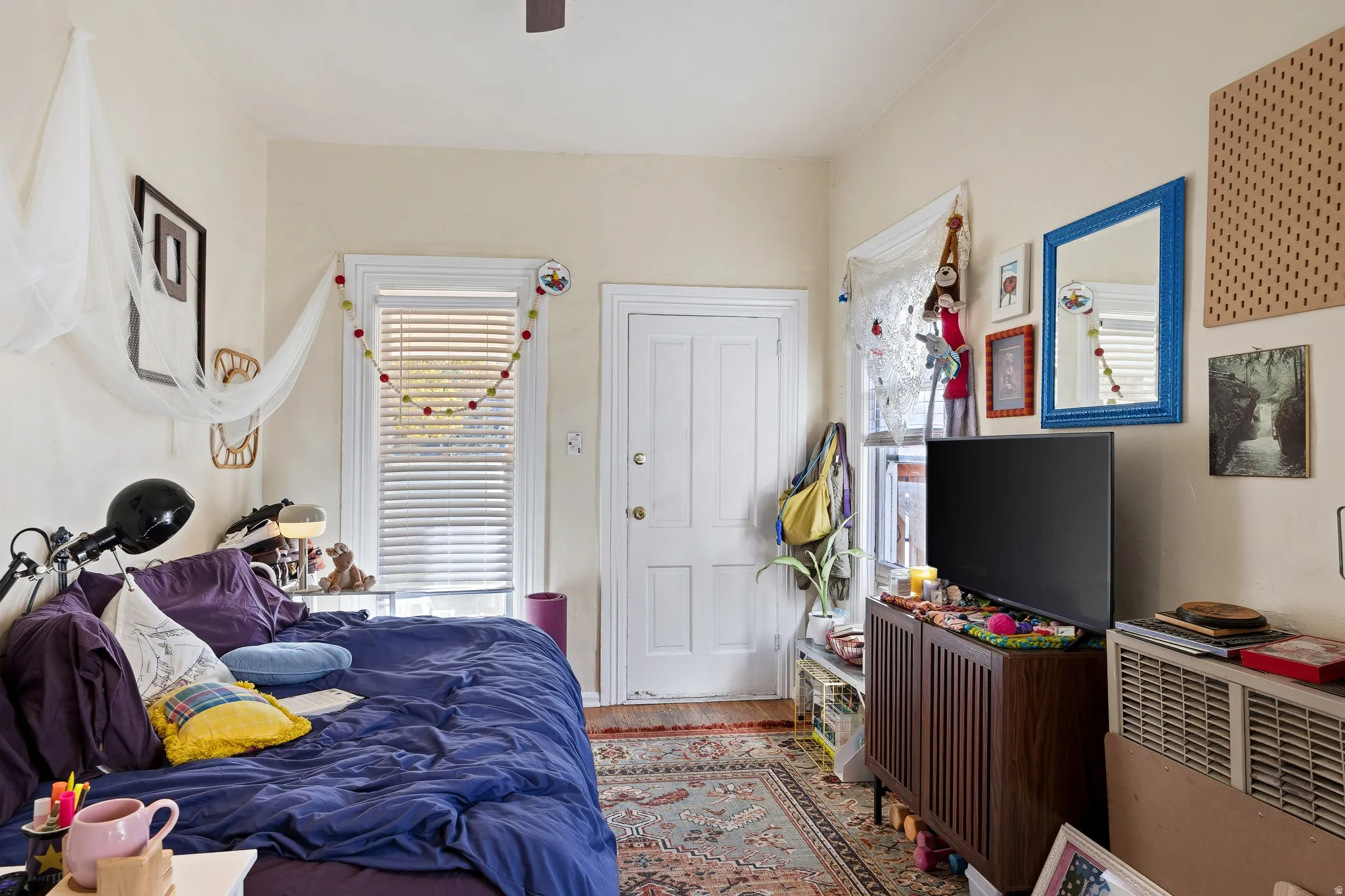 Bedroom featuring wood finished floors and a ceiling fan
