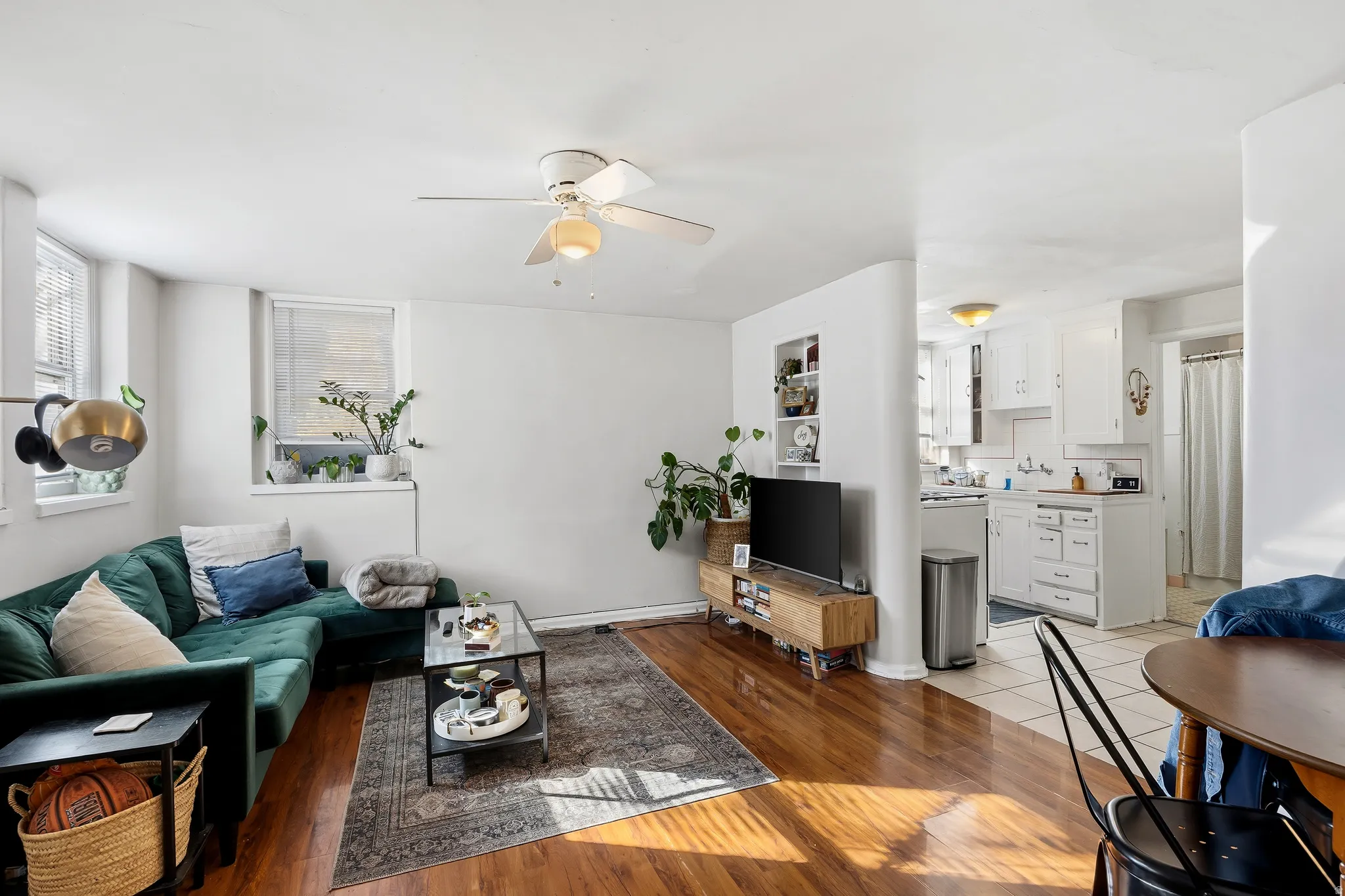 Living area featuring light wood finished floors and a ceiling fan