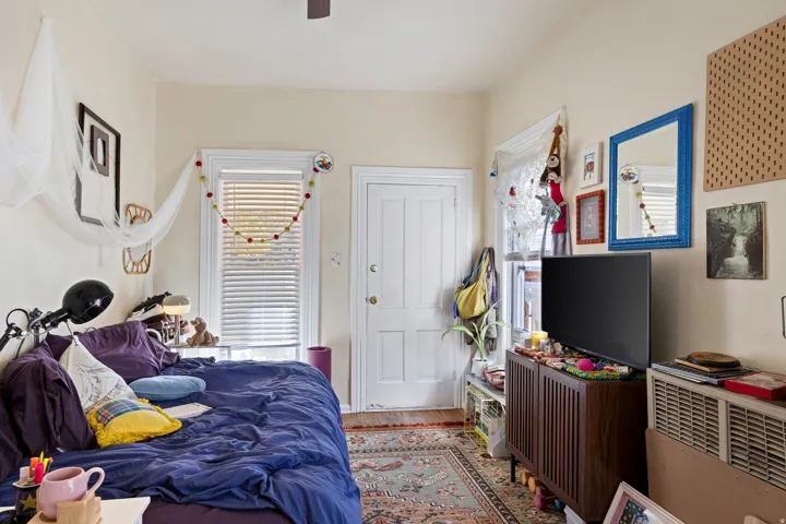 Bedroom featuring wood finished floors and a ceiling fan