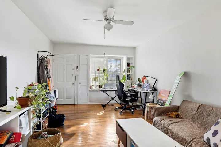 Living area featuring an office area, light wood-style flooring, and ceiling fan