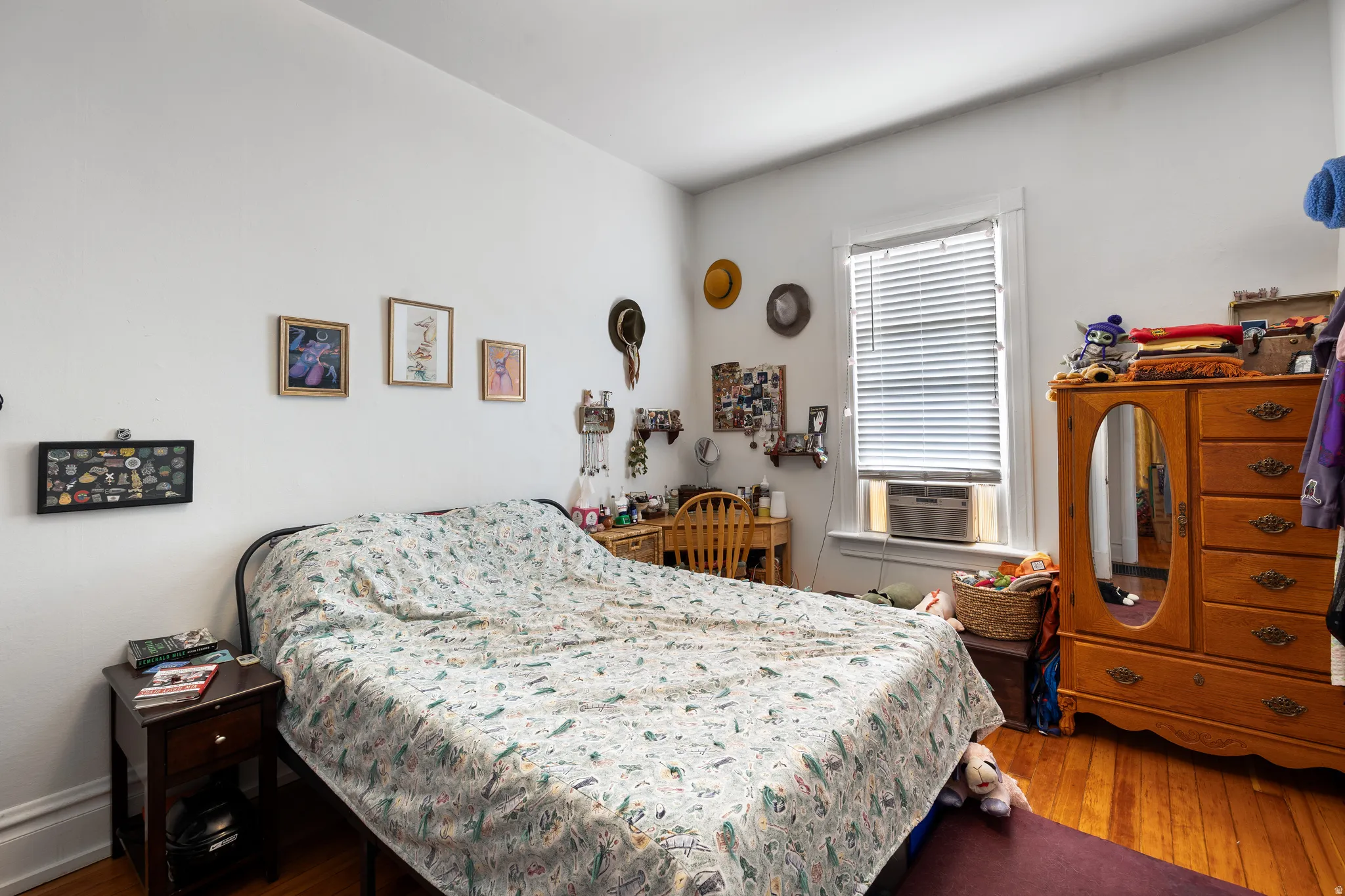 Bedroom with wood finished floors and cooling unit