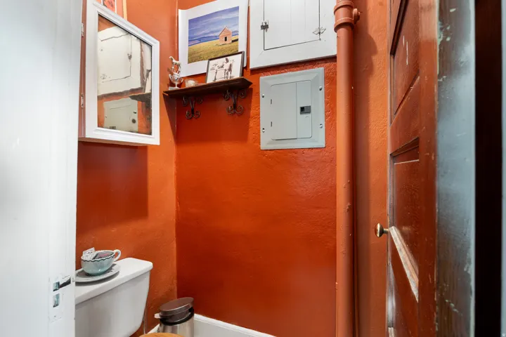 Bathroom with electric panel and a textured wall