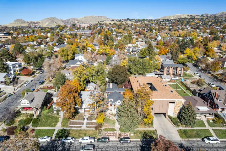Aerial view of property's location featuring a mountainous background and nearby suburban area