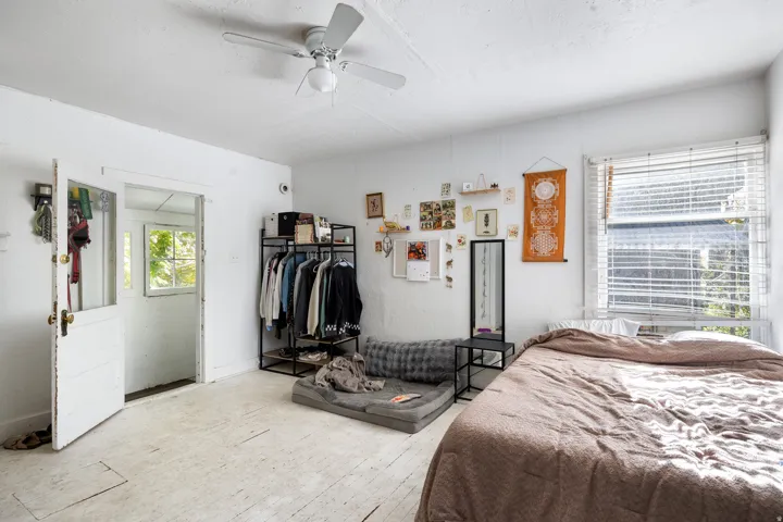 Bedroom with a ceiling fan and hardwood / wood-style flooring