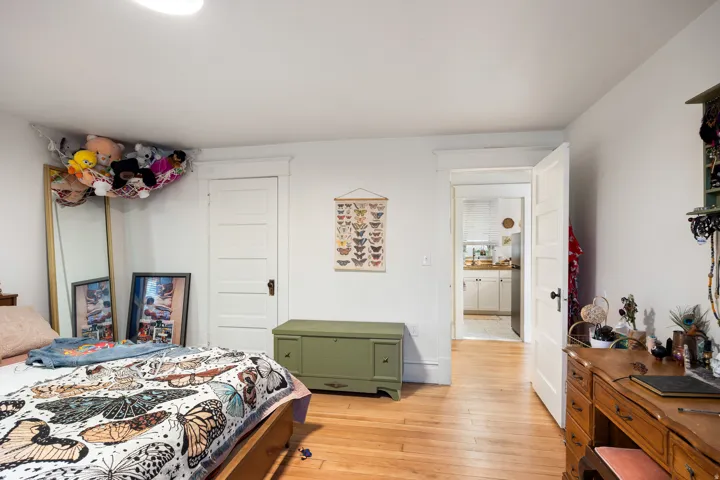 Bedroom featuring light wood-style floors and a closet