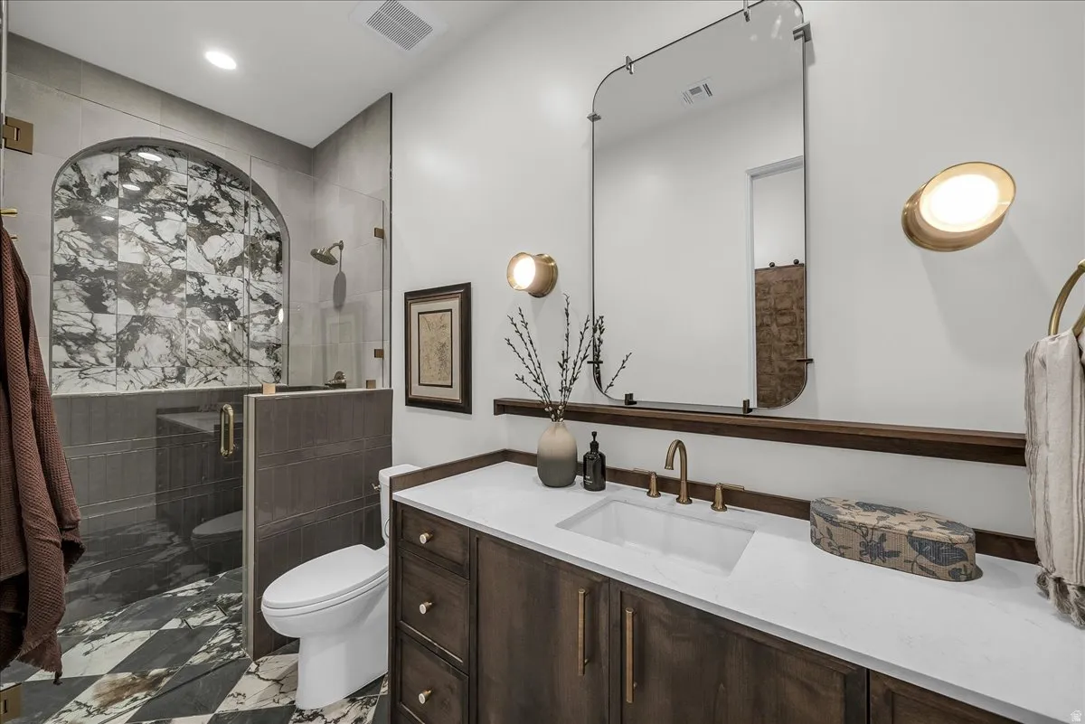 Full hall bath featuring vanity, a shower stall, and recessed lighting