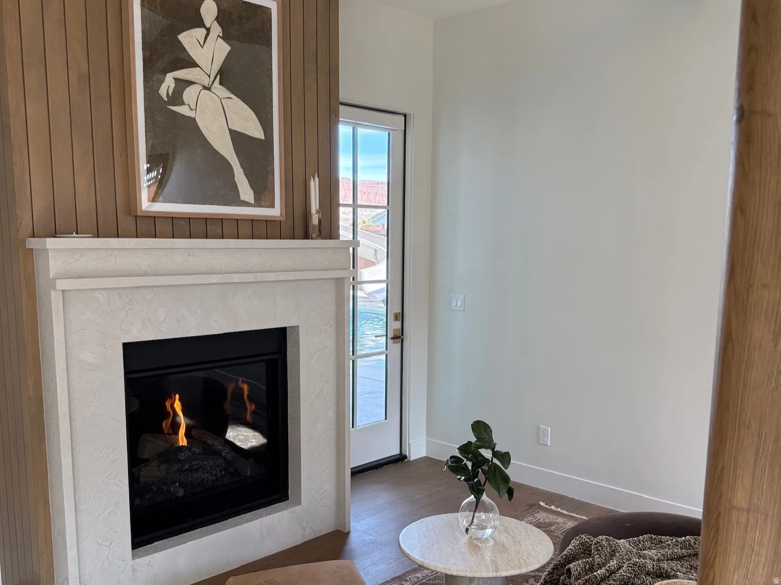 Primary suite fireplace and door to outside oasis