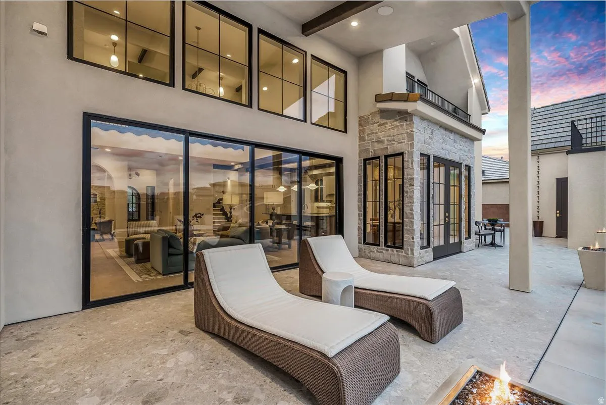 Patio terrace at dusk with a patio and a fire pit