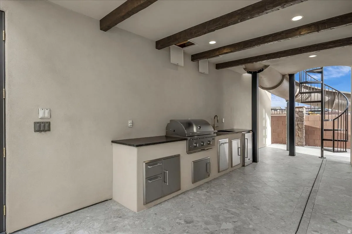 Covered outdoor kitchen, spiral stairs to the slide and jump deck