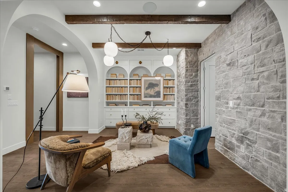 eaturing recessed lighting, arched walkways, wood finished floors, and beam ceiling