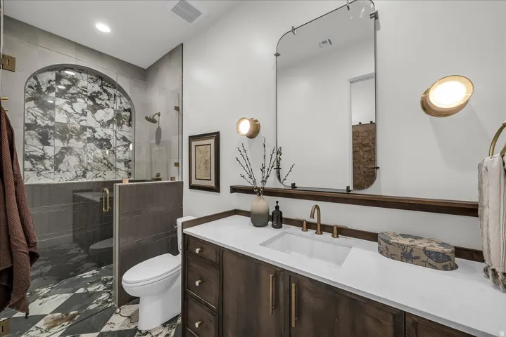 Full hall bath featuring vanity, a shower stall, and recessed lighting