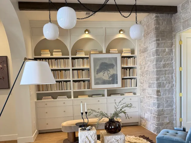 Living area featuring beamed ceiling, built in shelves, and wood finished floors