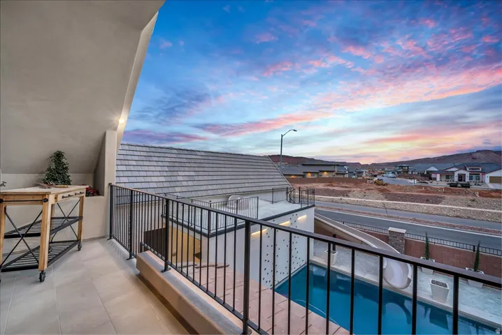 Balcony off bedroom with view of pool