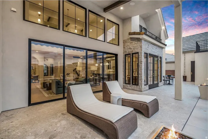 Patio terrace at dusk with a patio and a fire pit