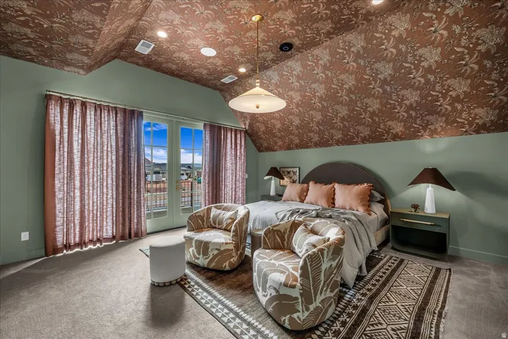 Bedroom with vaulted ceiling, access to outside, carpet floors, and french doors