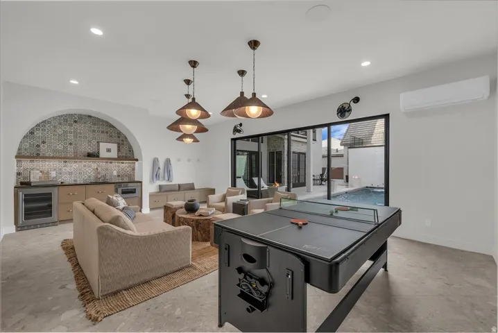 Rec room opens to the pool with kitchenette