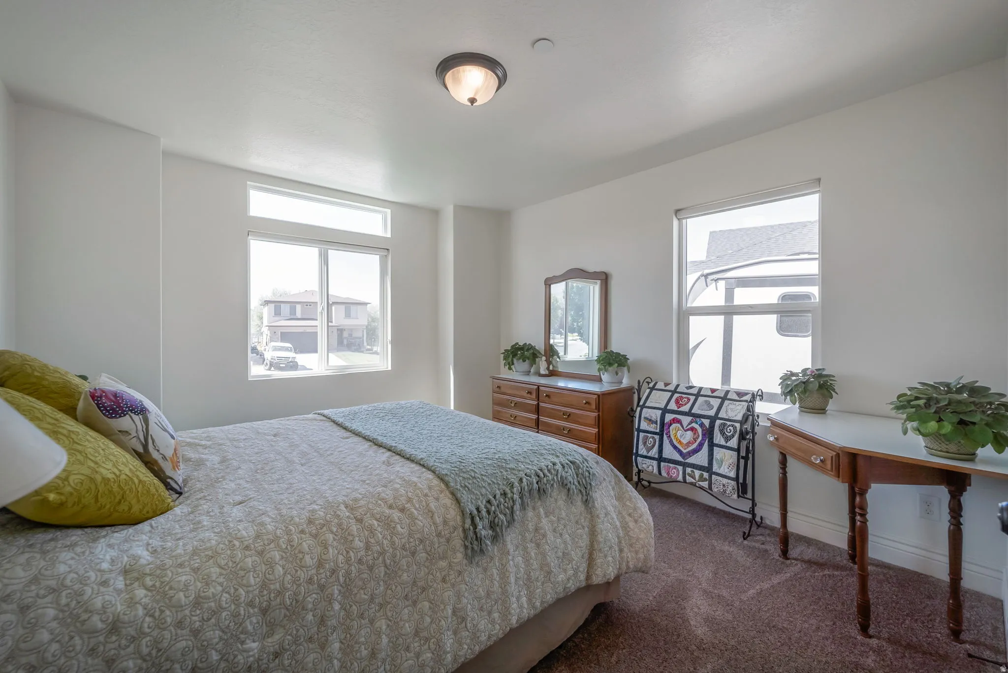 Bedroom with dark colored carpet and baseboards
