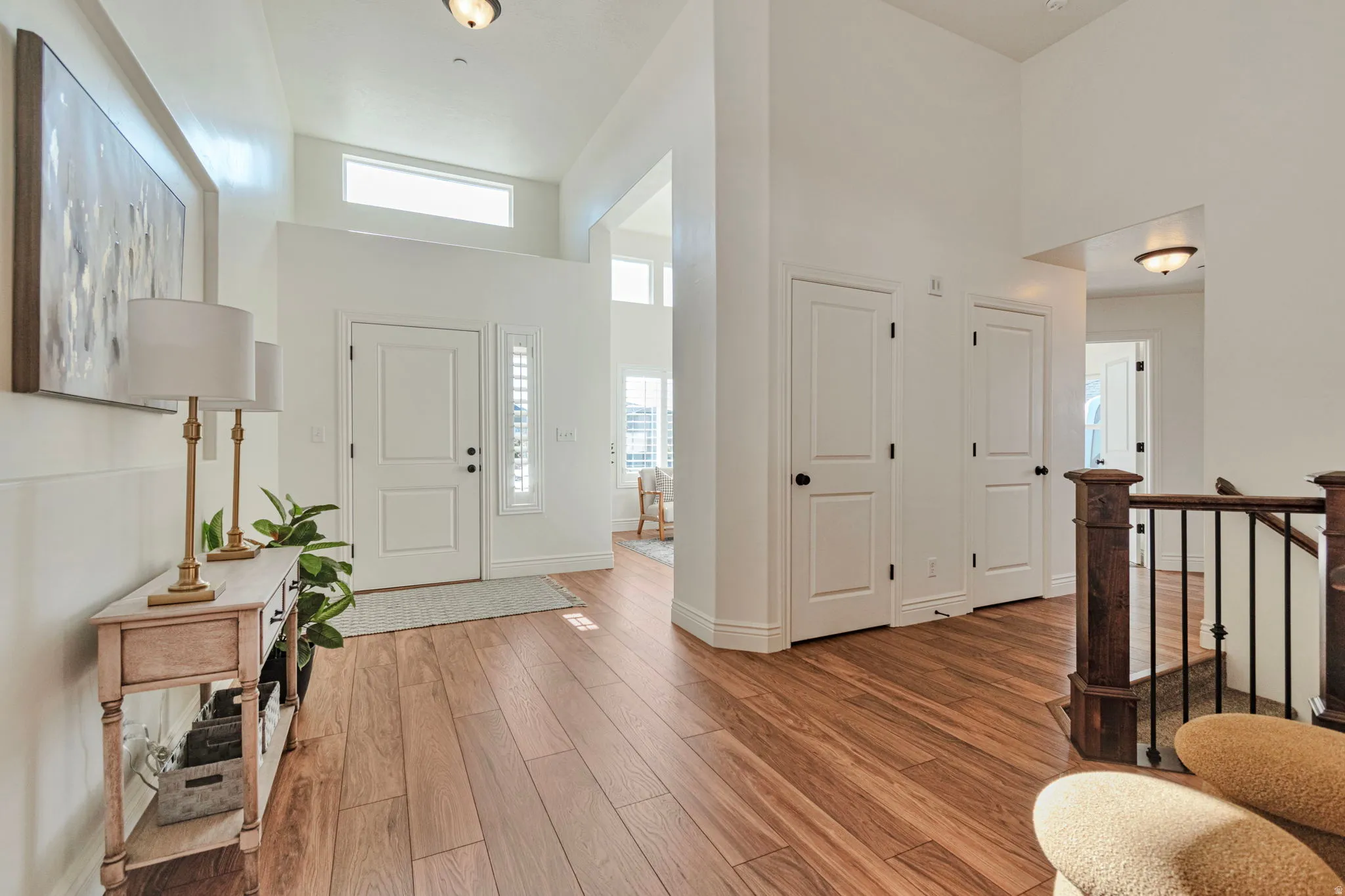 Entrance foyer with a high ceiling and light wood-style flooring