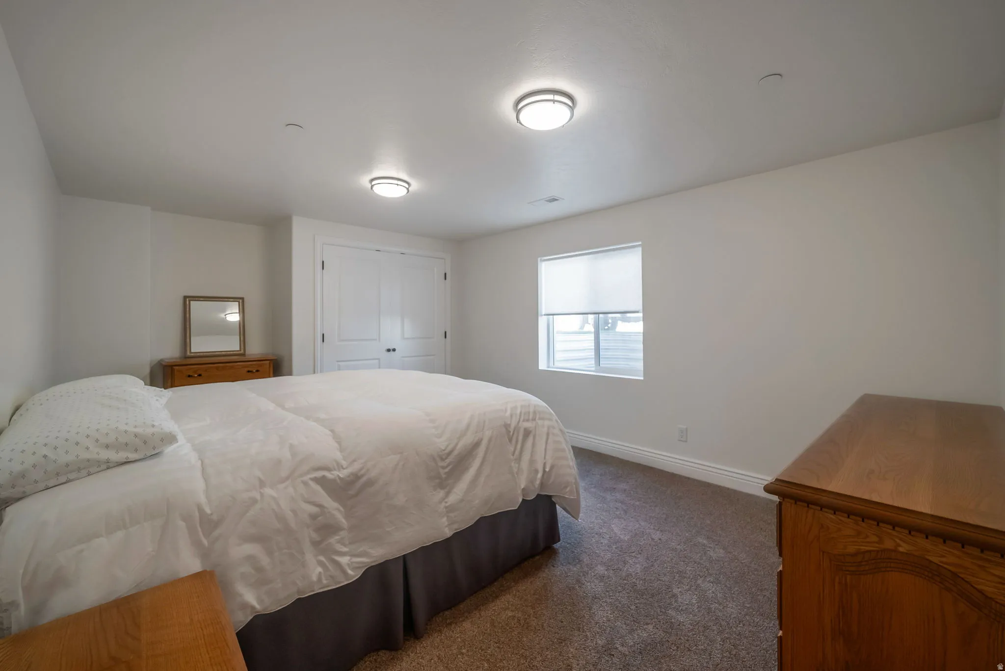 Bedroom featuring dark carpet and a closet