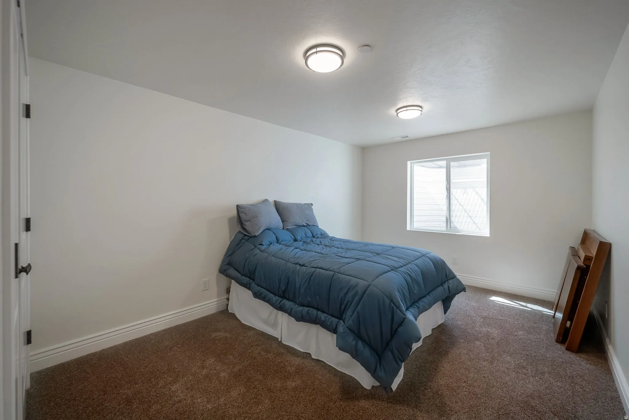 Carpeted bedroom featuring baseboards