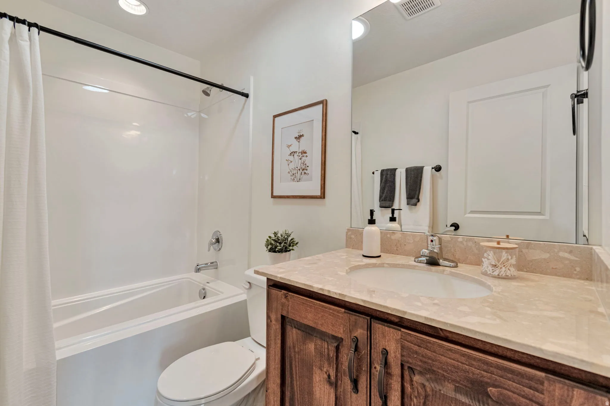 Bathroom with vanity and shower / tub combo