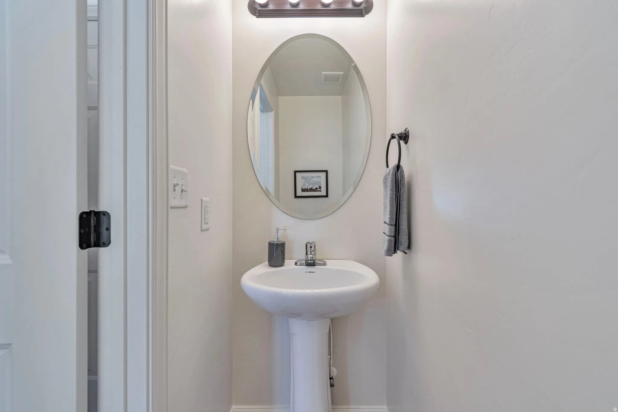Bathroom featuring baseboards and a sink