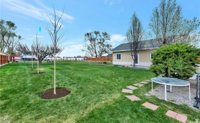 View of yard with a trampoline