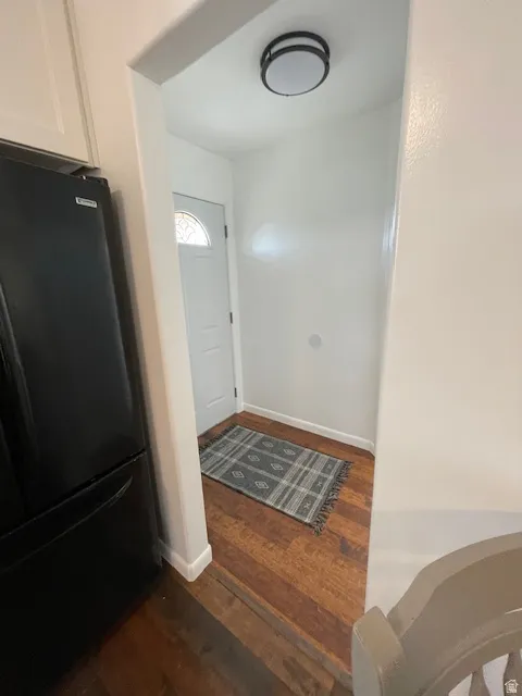 Entrance foyer featuring baseboards and dark wood-style flooring