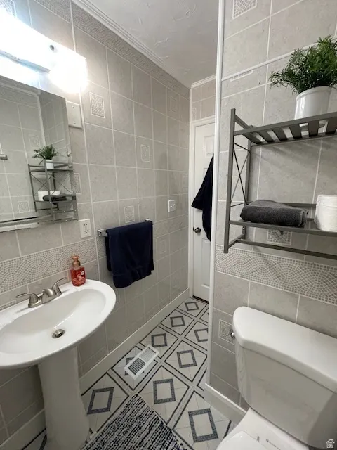Bathroom featuring tile walls and light tile patterned floors