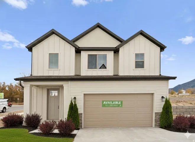 Modern inspired farmhouse featuring board and batten siding, an attached garage, driveway, and a mountain view