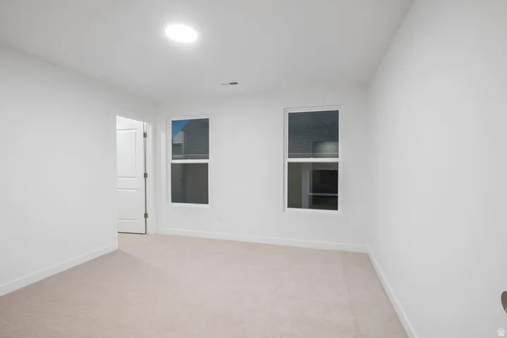Spare room with light colored carpet