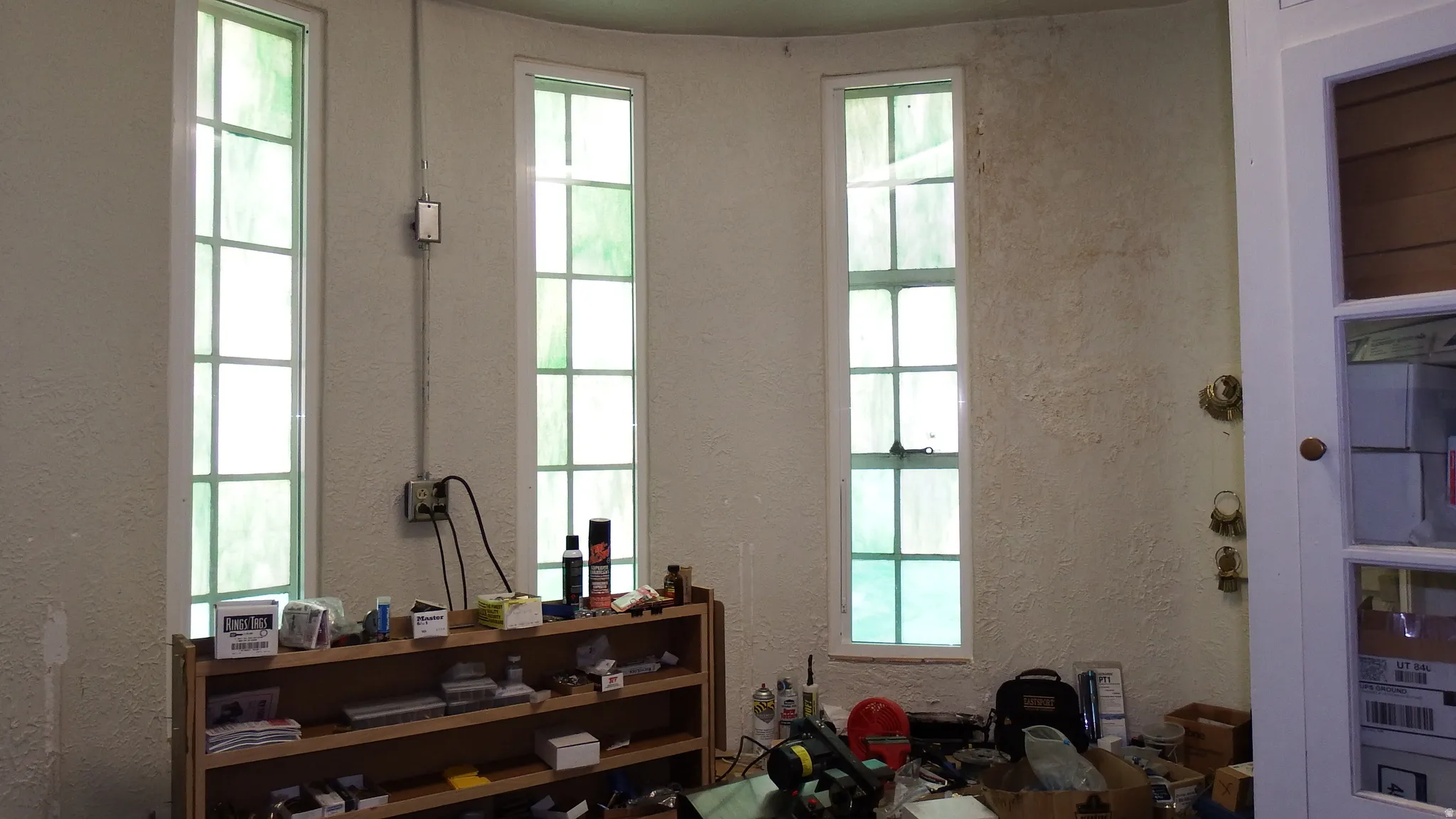 Misc room with a textured wall and plenty of natural light