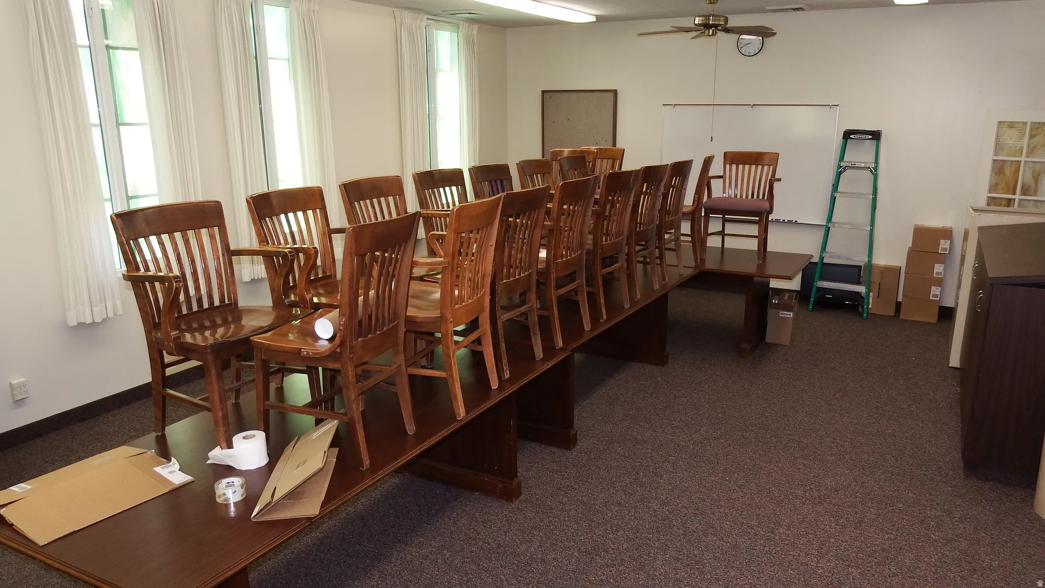Dining room with healthy amount of natural light, a ceiling fan, and dark carpet