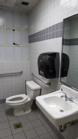 Bathroom featuring tile walls and light tile patterned flooring