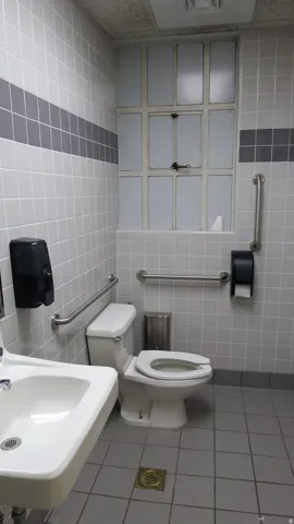Half bathroom with tile walls and tile patterned floors