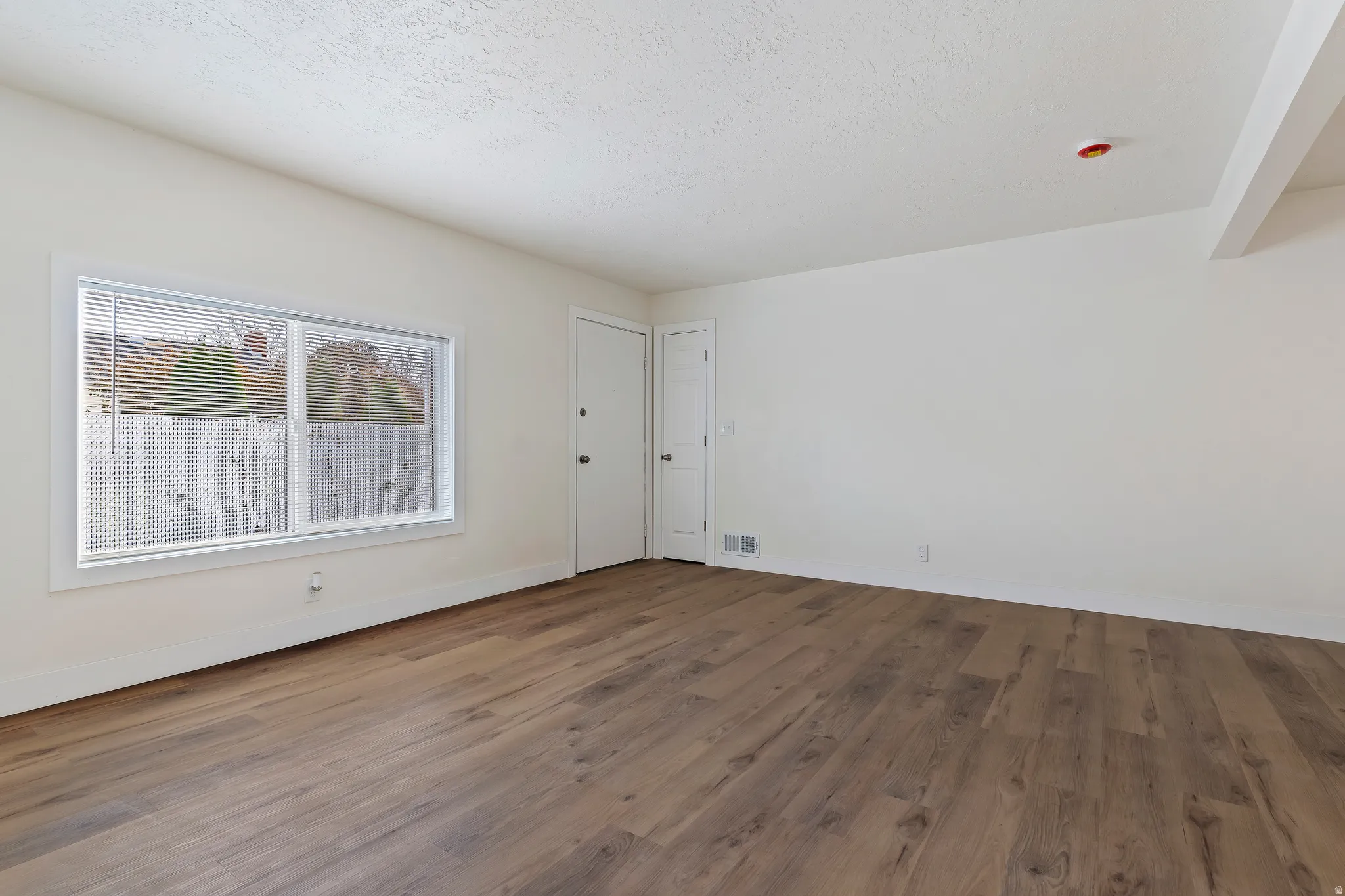 Unit 2 Living room with dark wood-style floors and a textured ceiling