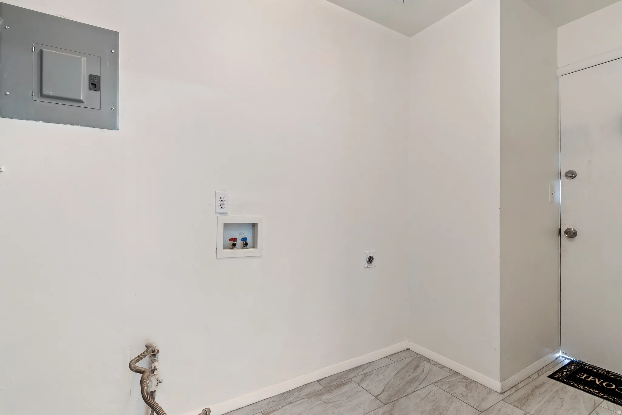 Unit 1 washroom featuring electric panel, washer hookup, and hookup for an electric dryer