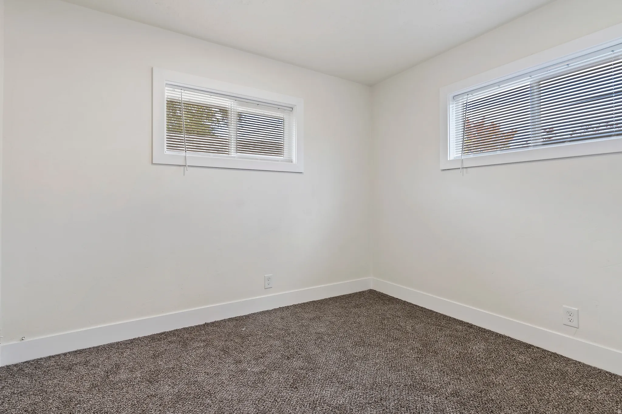 Carpeted bedroom featuring baseboards
